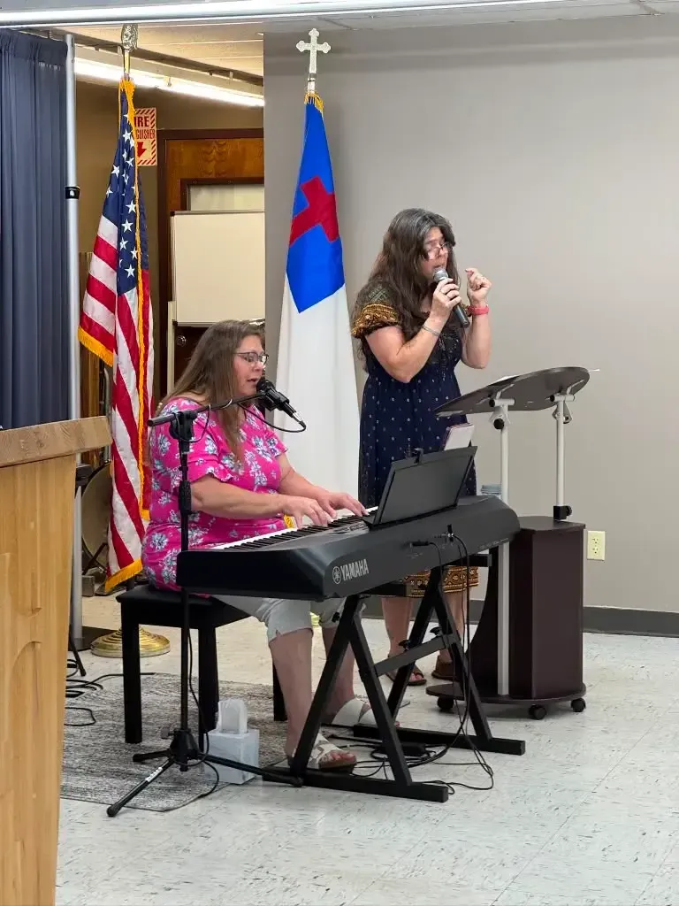 Praise team leading worship with keyboard and vocals