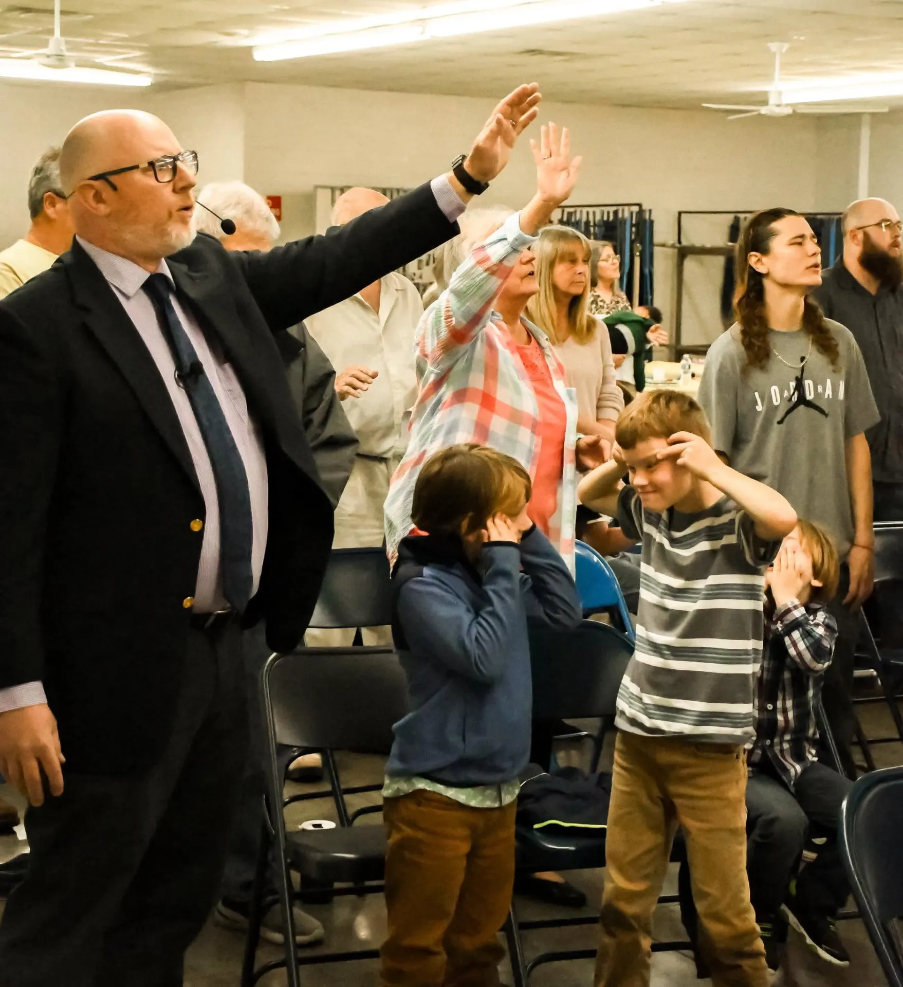 Congregation worshiping with hands raised
